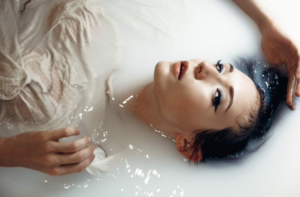 Woman taking a bubble bath.